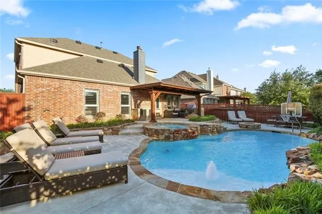 Custom natural pool with outdoor covered patio