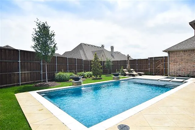 Luxury rectangular pool design with turf accents