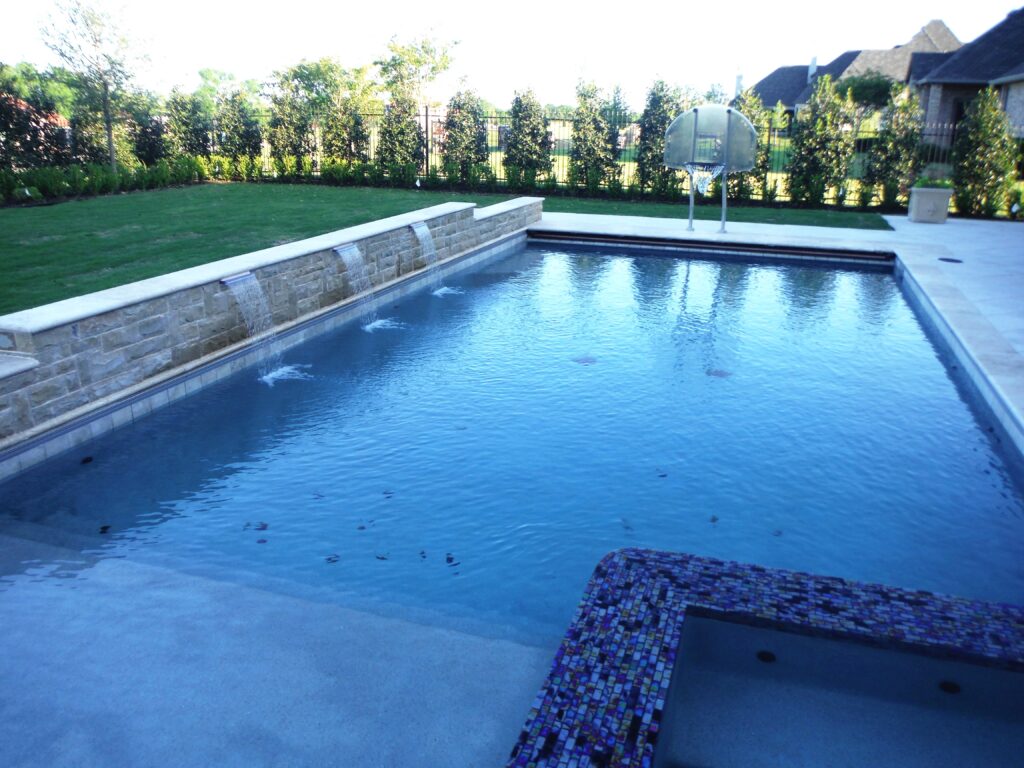 Luxury rectangular pool design with turf accents