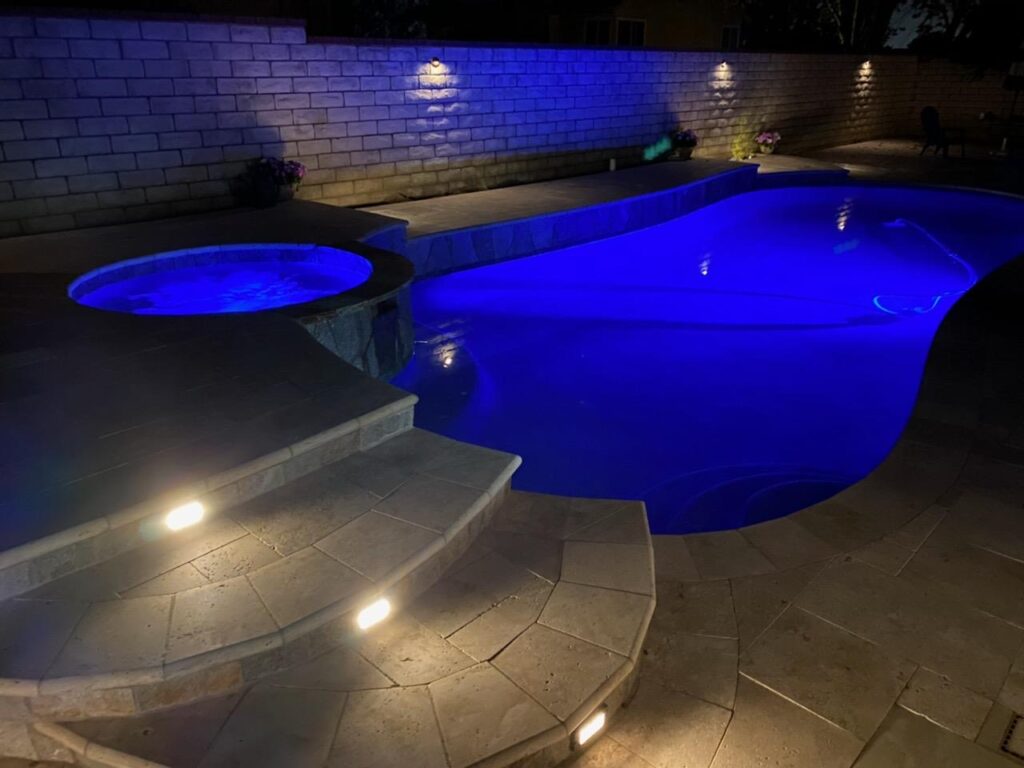 Luxury custom pool with outdoor lighting