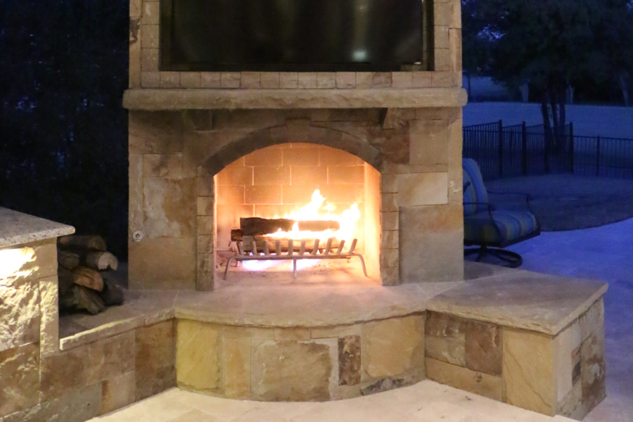 covered patio with outdoor fireplace